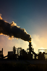 Image showing Smoking chimney  at sunset 