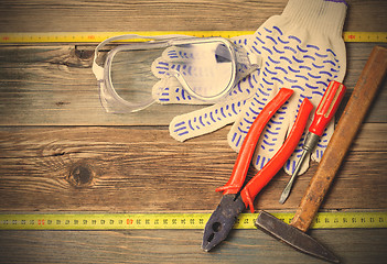 Image showing set of the old locksmith tools, safety glasses and work gloves