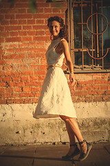 Image showing beautiful middle-aged woman in a white dress