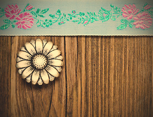 Image showing vintage aqua color tape with embroidered ornaments and old butto