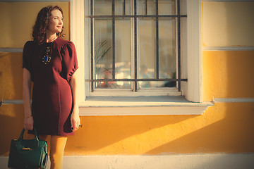 Image showing beautiful woman in a maroon dress
