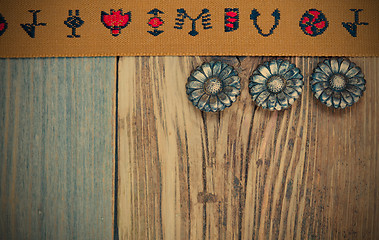 Image showing vintage brown band with embroidered ornaments and old buttons