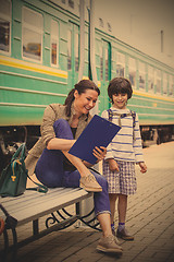 Image showing mother and son waiting for a train