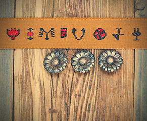 Image showing vintage tape with embroidered ornaments and old buttons