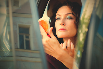 Image showing pretty middle-aged woman checked the makeup