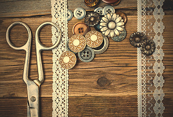 Image showing antique lace, button and a tailor scissors