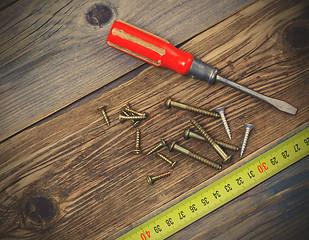 Image showing group of screw with a screwdriver