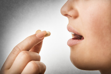 Image showing closeup taking pill
