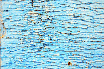 Image showing dirty stripped paint in the blue wood door  nail