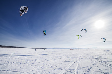 Image showing Kiteboarder with blue kite on the snow