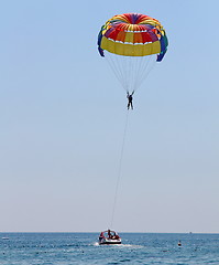 Image showing Parasailing in a blue sky