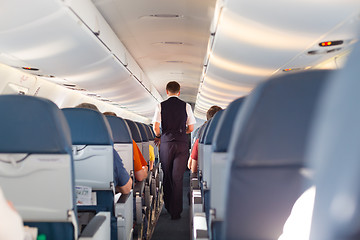 Image showing Steward on the airplane.