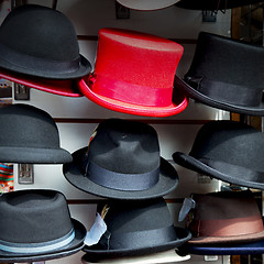 Image showing in london old red hat and black  the  fashion shop