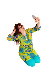 Image showing Woman taking selfie kneeling.