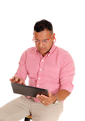 Image showing Closeup of man working on tablet pc.