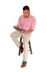 Image showing Hispanic man sitting with tablet pc.