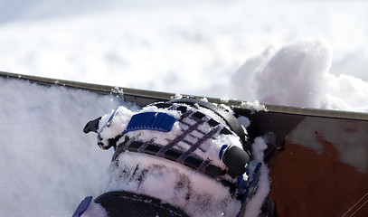 Image showing Snowboard and boot in binding on off-piste slope