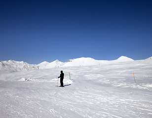 Image showing Skier on ski slope at sun day