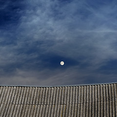 Image showing tiled top of the roof and cloudy blue sky