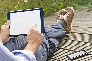 Image showing Using a tablet outside 