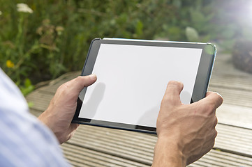 Image showing Connectivity: Man using tablet outdoors