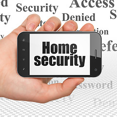 Image showing Security concept: Home Security on Hand Holding Smartphone display