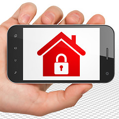 Image showing Business concept: Home on Hand Holding Smartphone display