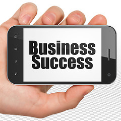 Image showing Finance concept: Business Success on Hand Holding Smartphone display
