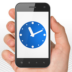 Image showing Timeline concept: Hand Holding Smartphone with Clock on display