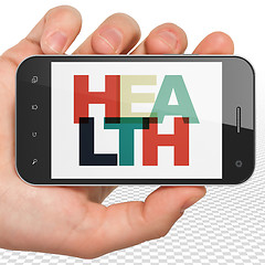 Image showing Medicine concept: Hand Holding Smartphone with Health on display