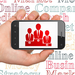 Image showing Advertising concept: Business Team on Hand Holding Smartphone display