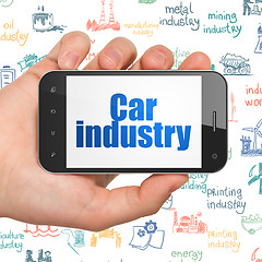 Image showing Industry concept: Car Industry on Hand Holding Smartphone display