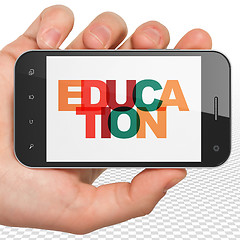 Image showing Studying concept: Hand Holding Smartphone with Education on display