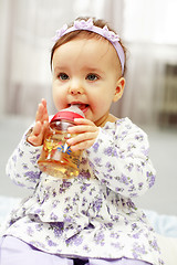 Image showing Cute baby is drinking tea