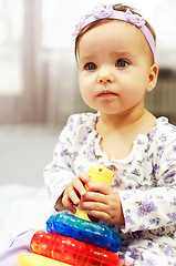 Image showing Baby plays with toys