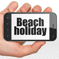 Image showing Travel concept: Beach Holiday on Hand Holding Smartphone display