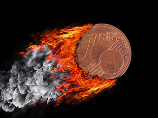Image showing Burning coin with a trail of fire and smoke