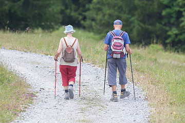 Image showing Senior tourist couple hiking at the beautiful mountains