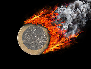 Image showing Burning coin with a trail of fire and smoke