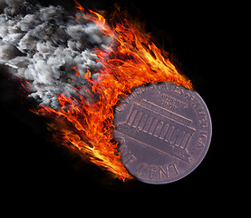 Image showing Burning coin with a trail of fire and smoke