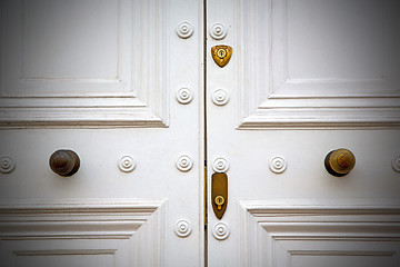 Image showing handle in london antique brown door  rusty  brass nail and light