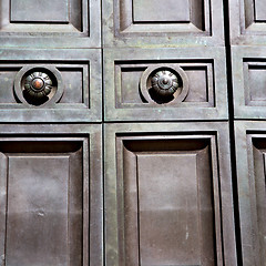 Image showing in london antique brown door  rusty  brass nail and light