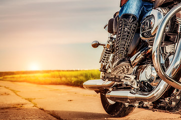 Image showing Biker girl riding on a motorcycle