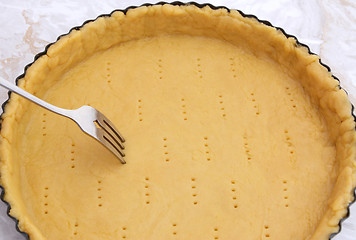 Image showing Fork making holes in a raw pastry case