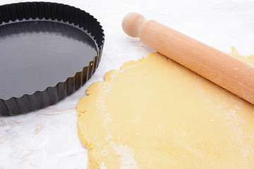 Image showing Baking tin next to shortcrust pastry and rolling pin