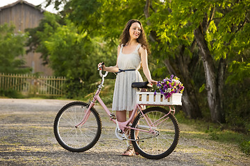 Image showing Happy girl with her bicycle