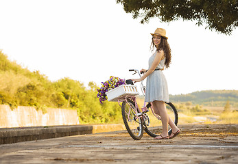 Image showing Happy girl with her bicycle