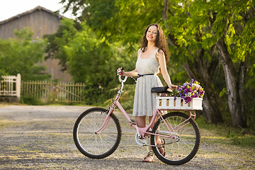 Image showing Happy girl with her bicycle