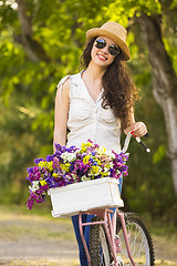 Image showing Happy girl with her bicycle