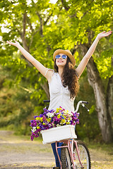 Image showing Happy girl with her bicycle